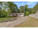 Ranch style home with a large deck and driveway at 4761 Lincoln Ne Dr, Kennesaw, GA 30144