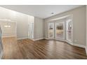 Bright living room with hardwood floors and bay windows at 7124 Big Woods Dr, Woodstock, GA 30189