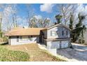 Gray two-story home with a two car garage and a light brown roof at 2545 Kingswood Dr, Marietta, GA 30066