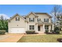 Two-story house with a large front yard and attached garage at 308 Evening Rain Crst, Canton, GA 30114