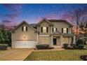 Two story house with large windows and attached garage at 308 Evening Rain Crst, Canton, GA 30114