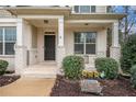 Inviting front porch with brick columns and a welcoming sign at 308 Evening Rain Crst, Canton, GA 30114