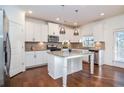 Modern kitchen with white cabinets, granite counters, and stainless steel appliances at 308 Evening Rain Crst, Canton, GA 30114