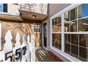 Townhome entrance with brick accents, white picket fence, and large windows at 557 Summit Sw Ln, Marietta, GA 30008