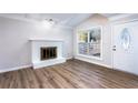 Bright living room featuring hardwood floors, a fireplace, and large windows at 557 Summit Sw Ln, Marietta, GA 30008