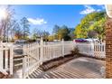 Private patio area with white picket fence and gate, offering a peaceful outdoor space at 557 Summit Sw Ln, Marietta, GA 30008