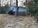 Side view of a ranch home nestled among trees at 905 Nw Magna Carta Dr, Atlanta, GA 30318