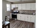 White cabinets, granite countertops, and stainless steel appliances at 1625 Conley Rd # 138, Conley, GA 30288