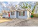 View of a blue ranch home with a red door and driveway at 1927 Vicki Se Ln, Atlanta, GA 30316