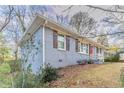 Side view of a ranch home showcasing its blue exterior and landscaping at 1927 Vicki Se Ln, Atlanta, GA 30316