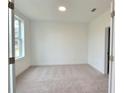 Bright and spacious bedroom with neutral carpeting and large window at 4802 Larkin Pass, Buford, GA 30518