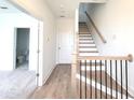 Light oak staircase with black metal railing and hardwood floors at 4802 Larkin Pass, Buford, GA 30518