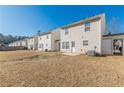 Row of townhouses with grassy backyards and patios at 320 Goldenrod Dr, Stockbridge, GA 30281