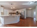 Modern kitchen with white cabinets, quartz countertops, and stainless steel appliances at 910 Callee Dr, Loganville, GA 30052