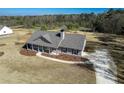 Inviting one-story home with long driveway and pristine landscaping at 85 Woodfin Way, Social Circle, GA 30025