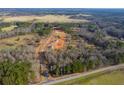 Scenic aerial view of a new construction homes on spacious lots surrounded by lush trees and beautiful landscapes at 85 Woodfin Way, Social Circle, GA 30025
