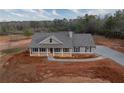 Charming single-story home with a welcoming porch and newly installed driveway, set in a rural area at 85 Woodfin Way, Social Circle, GA 30025