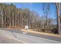 Street view featuring 'The Oaks' signage for new construction homes, set in a quiet location at 85 Woodfin Way, Social Circle, GA 30025