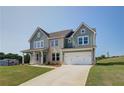 Two-story house with gray siding, stone accents, and a two-car garage at 151 Buffalo Trce, Stockbridge, GA 30281