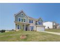 Two-story house with gray siding, stone accents, and a two-car garage at 151 Buffalo Trce, Stockbridge, GA 30281