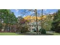 Two-story house nestled among colorful autumn trees at 7470 Wynfield Dr, Cumming, GA 30040