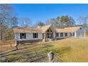 White ranch house with stone accents and a two car garage at 1609 N County Line Rd, Lithia Springs, GA 30122