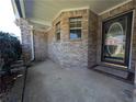 Front porch with a brick exterior and a black door at 406 Trinkle Ct, Stockbridge, GA 30281