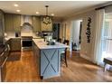 Kitchen features stainless appliances, an island with marble countertop, and hardwood flooring at 747 Dogwood Cir, Norcross, GA 30071