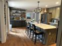 Bright kitchen with updated appliances, hardwood floors, marble counters, and seating at island at 747 Dogwood Cir, Norcross, GA 30071