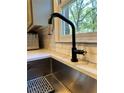 Modern black gooseneck kitchen faucet and sink at 747 Dogwood Cir, Norcross, GA 30071