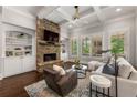 Inviting living room showcases a stone fireplace, built-in shelving, hardwood floors, and ample natural light at 5330 Lake Redwine Nw Cv, Acworth, GA 30101