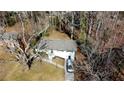 Ranch house nestled in a wooded area with a driveway at 1394 Yates Ave, Austell, GA 30106