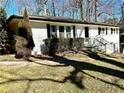 Updated white brick ranch house with landscaping and a walkway at 1394 Yates Ave, Austell, GA 30106