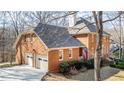 Two-car garage with a brick exterior and white doors at 266 Mossy Nw Way, Kennesaw, GA 30152