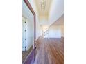 Bright entryway with hardwood floors, high ceilings, and a view to the staircase and living areas at 5450 Crow Dr, Cumming, GA 30041