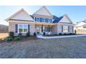 Two-story home with gray brick, shutters, and a covered porch at 5450 Crow Dr, Cumming, GA 30041