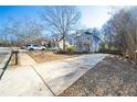 Quaint home with a cozy front porch on a lot with a long driveway and mature trees at 110 Bowen Sw Cir, Atlanta, GA 30315