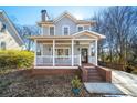 Inviting home featuring a cozy front porch with brick steps and neat landscaping at 110 Bowen Sw Cir, Atlanta, GA 30315