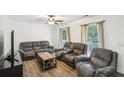 Relaxing living room with hardwood floors and large windows at 3980 Carlton Cove Ct, Loganville, GA 30052