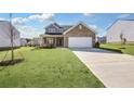 Two-story home with brick and siding exterior, two-car garage, and landscaped lawn at 509 Elkwood Ln, Mcdonough, GA 30252