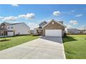 Two-story home with brick and siding exterior, two-car garage, and landscaped lawn at 509 Elkwood Ln, Mcdonough, GA 30252