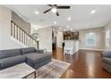 Spacious living room with hardwood floors, fireplace, and gray sectional sofa at 1043 Belmont Commons Dr, Smyrna, GA 30080