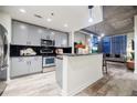 Modern kitchen with gray cabinets, granite counters, and stainless steel appliances at 250 Pharr Ne Rd # 602, Atlanta, GA 30305