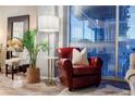 Elegant living room featuring a leather armchair and large window with blinds at 250 Pharr Ne Rd # 602, Atlanta, GA 30305