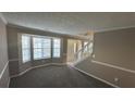 Spacious living room with bay window and neutral carpeting at 710 Ridge Way, Lithonia, GA 30058