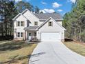 Two-story house with gray siding, stone accents, and a two-car garage at 116 Carriage Oak Dr, Villa Rica, GA 30180