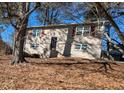 Tan two-story house with red shutters and tree-lined yard at 2531 Ridgecrest Nw Dr, Kennesaw, GA 30152