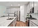 Modern kitchen features stainless steel appliances and granite countertops at 455 Duval Dr, Alpharetta, GA 30009