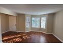 Living room featuring hardwood floors and bay windows at 4489 Carriage Park Dr, Lithonia, GA 30038