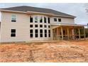 Rear view of a two-story house featuring a sunroom and large windows for ample natural light at 4830 Cool Springs Rd, Winston, GA 30187